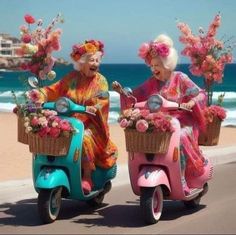 two older women riding scooters with flowers in baskets on the front and back