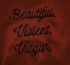 the words beautiful, violent, yugar written in cursive writing on a red cloth