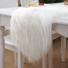 PRICES MAY VARY. Polyester Size: The white fur table runner measures about 30x150 cm, Perfect for decorating your Christmas dining table, dresser, bench ,fireplace ,bed runner decor. Material: White Christmas table runner is made of fluffy faux fur: 100% polyester ,acrylic:20% , Bottom : 100% polyester (Note: The Runner is a vacuum compression package, you will see wrinkles when you open it for the first time, Please leave it for a few days and comb the fur smoothly ) Applications: Winter table Dresser Fireplace, Bench Fireplace, Winter Wonderland Tablescape, Fur Table, Winter Table Decor, Fireplace Decorations, Dresser Bench, Christmas Dining Table Decor, Christmas Dining Table