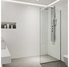 a bathroom with a toilet, sink and shower stall in the middle of the room