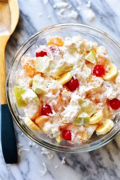 a bowl filled with fruit salad on top of a table