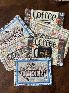 four embroidered coasters with coffee designs on them