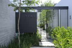 an entrance to a house with trees and plants