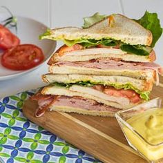 a cut in half sandwich sitting on top of a cutting board