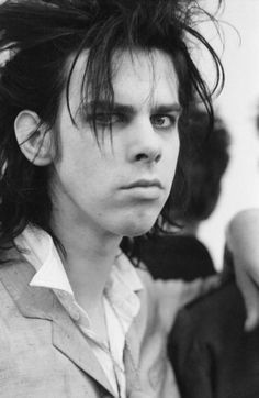 black and white photograph of a young man with hair blowing in the wind, looking to his left