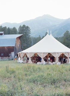 a large white tent sitting in the middle of a field