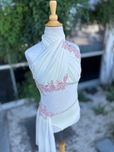 a mannequin wearing a white dress with pink flowers on it's chest