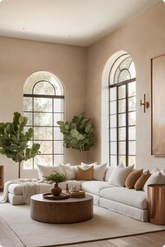 a living room filled with lots of furniture next to two large windows and a rug on the floor