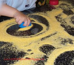 a toddler playing with yellow and black play dough