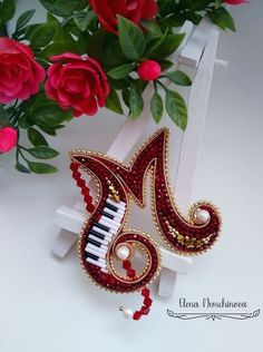 a red and white musical instrument with flowers in the background