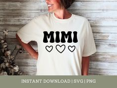 a woman wearing a t - shirt that says mimi with hearts on the front and back