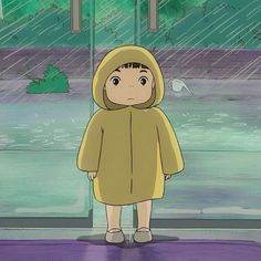 a person in a raincoat standing under an umbrella