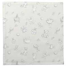 a white and gray baby blanket with teddy bears on it's side, in front of a polka dot background