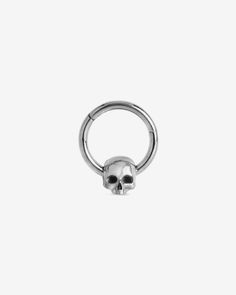 a silver ring with a skull on the front and back ends, set against a white background