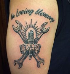 a man's arm with two wrenches and the words no loving memory on it