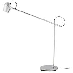 a lamp that is on top of a white surface with a cord attached to it