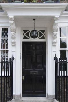 a black front door on a white house