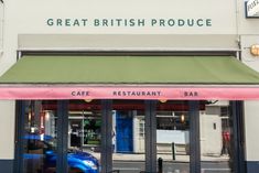 the entrance to a restaurant with pink and green awning