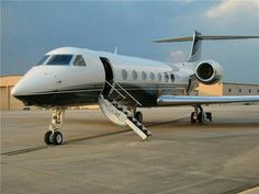 a private jet sits on the tarmac at an airport