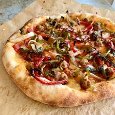 a pizza sitting on top of a piece of wax paper