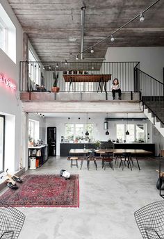 a large open floor plan with stairs leading up to the second story and dining area