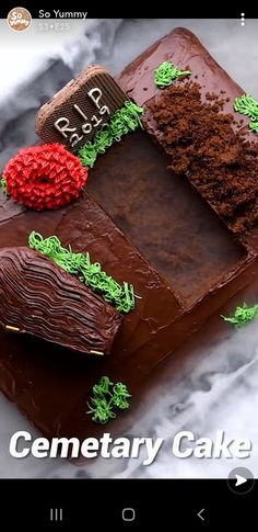 a chocolate cake with green and red decorations on it's side that says cemetery cake