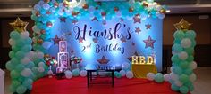 a stage set up for a two year old's birthday with balloons and stars