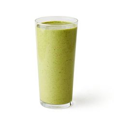 a green smoothie in a glass on a white background