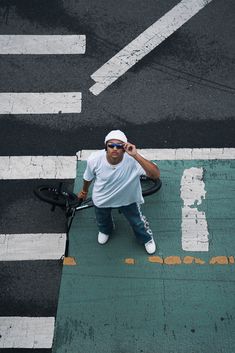 a man standing on the side of a road holding a tennis racquet