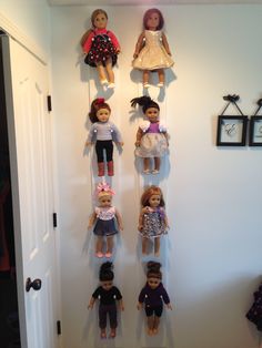 a group of dolls hanging on the wall