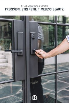 a man is opening the door with his hand and holding it in front of him