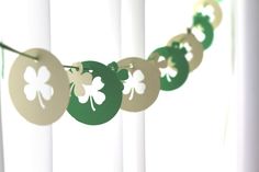 some paper shamrocks are hanging from a string