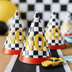 toy cars are lined up on the race track with cones that read 10 o'clock