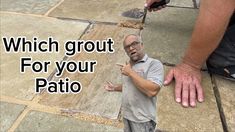 a man standing on top of a stone floor next to a hand pointing at something