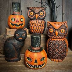 an assortment of carved pumpkins and owls with faces painted on them, all sitting next to each other