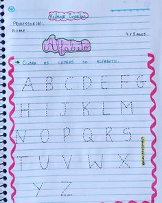 a handwritten alphabet is shown on lined paper with the letters in pink and blue