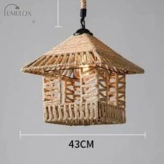 an image of a hanging lamp made out of straw and rope with measurements for the width