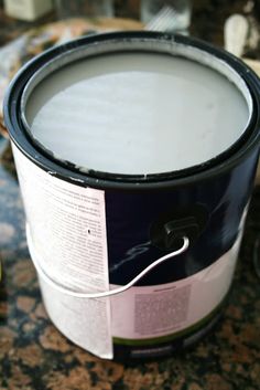 a can of paint sitting on top of a table