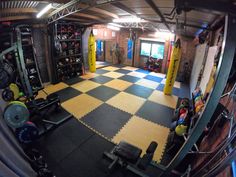 an indoor gym with yellow and black tiles