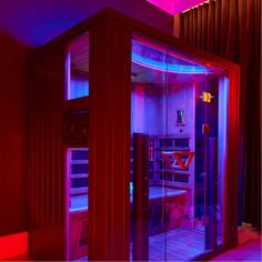 the inside of a sauna is lit up with red and blue lights on it