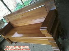 a wooden bench sitting in the middle of a room