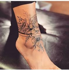 a woman's foot with flowers on it and the words, ide tattoo