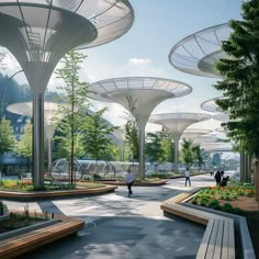 people are walking through an open space with trees and plants on either side of the walkway