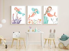 three children's art prints hanging on the wall above a table and chairs in a child's room