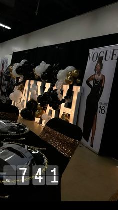 a table with black and gold decorations on it in front of a sign that says glamour