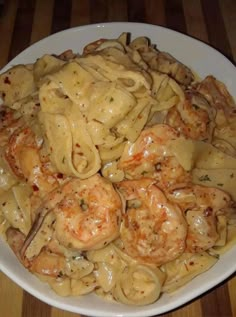 pasta with shrimp and sauce in a white bowl