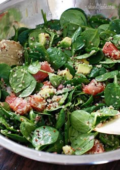 spinach salad with bacon and avocado in a bowl