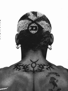 the back of a man's head with tattoos on it