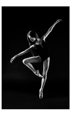 a black and white photo of a ballerina