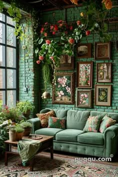 a living room filled with green furniture and lots of flowers hanging from the wall above